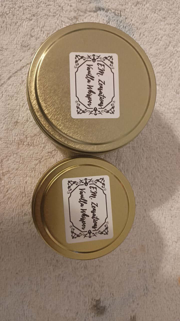 Vanilla Whisper Candle in gold tins with decorative labels, showcasing soft, calming scented candle features.