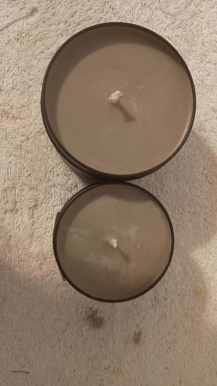 Chocolate Éclair Candle in two sizes, showcasing elegant design and candle wicks, perfect for home fragrance.